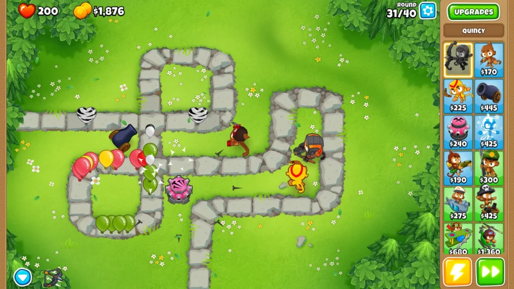 Monkey towers defend a path in Bloons TD 6