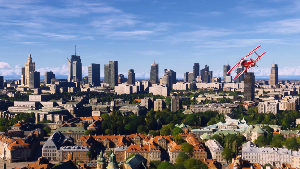A red aircraft flies over the Warsaw skyline in Microsoft Flight Simulator 2024.